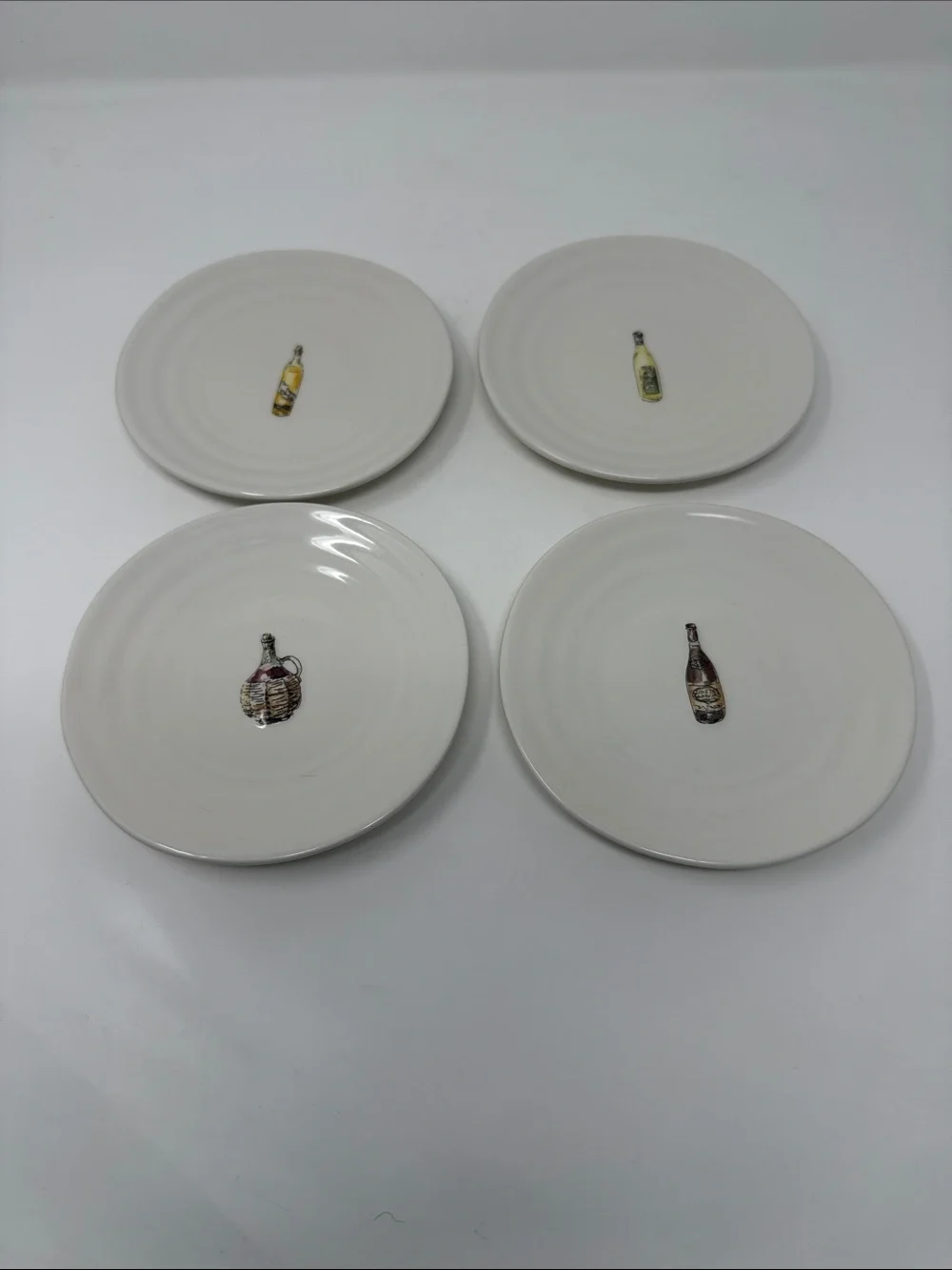 Williams Sonoma Cream Ceramic Dinner Plates with Wine Bottle Motifs - Set of 4